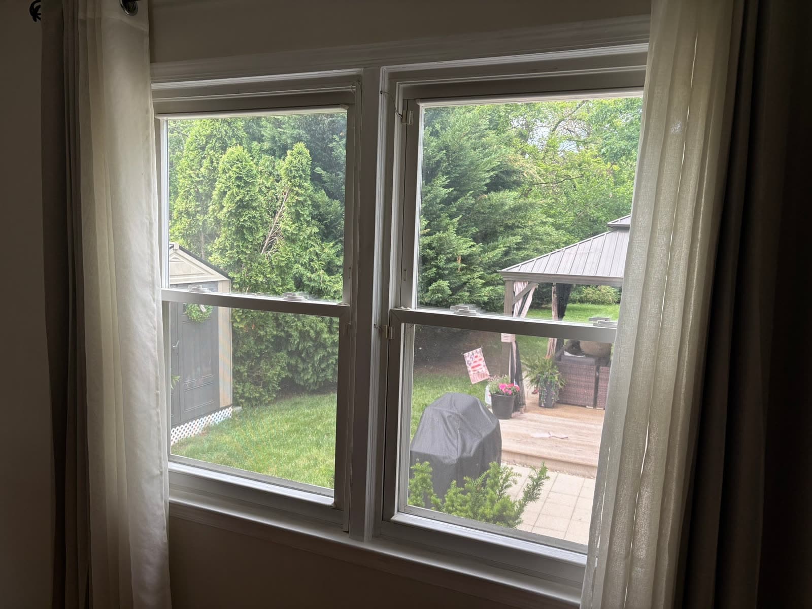 Interior view through tired existing double-hung windows on a New Jersey home, before Revive's replacement